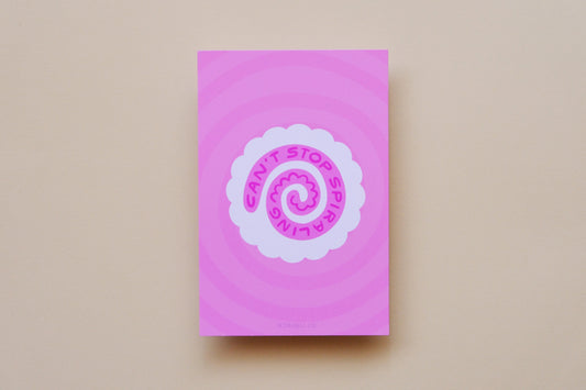 A JaneLi.Co mini print/postcard of a white fish cake with a pink spiral that says "Can't stop spiraling" over a pink background.