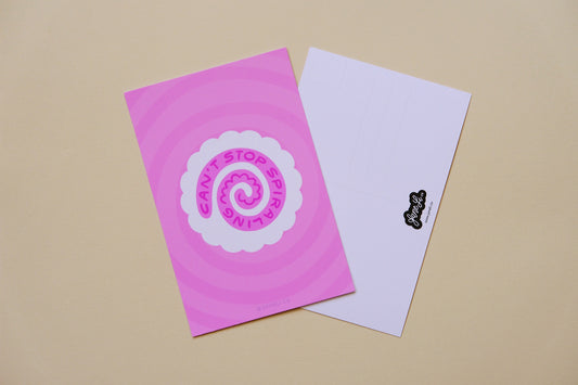 A JaneLi.Co mini print/postcard of a white fish cake with a pink spiral that says "Can't stop spiraling" and a back postcard side of the same print over a pink background.
