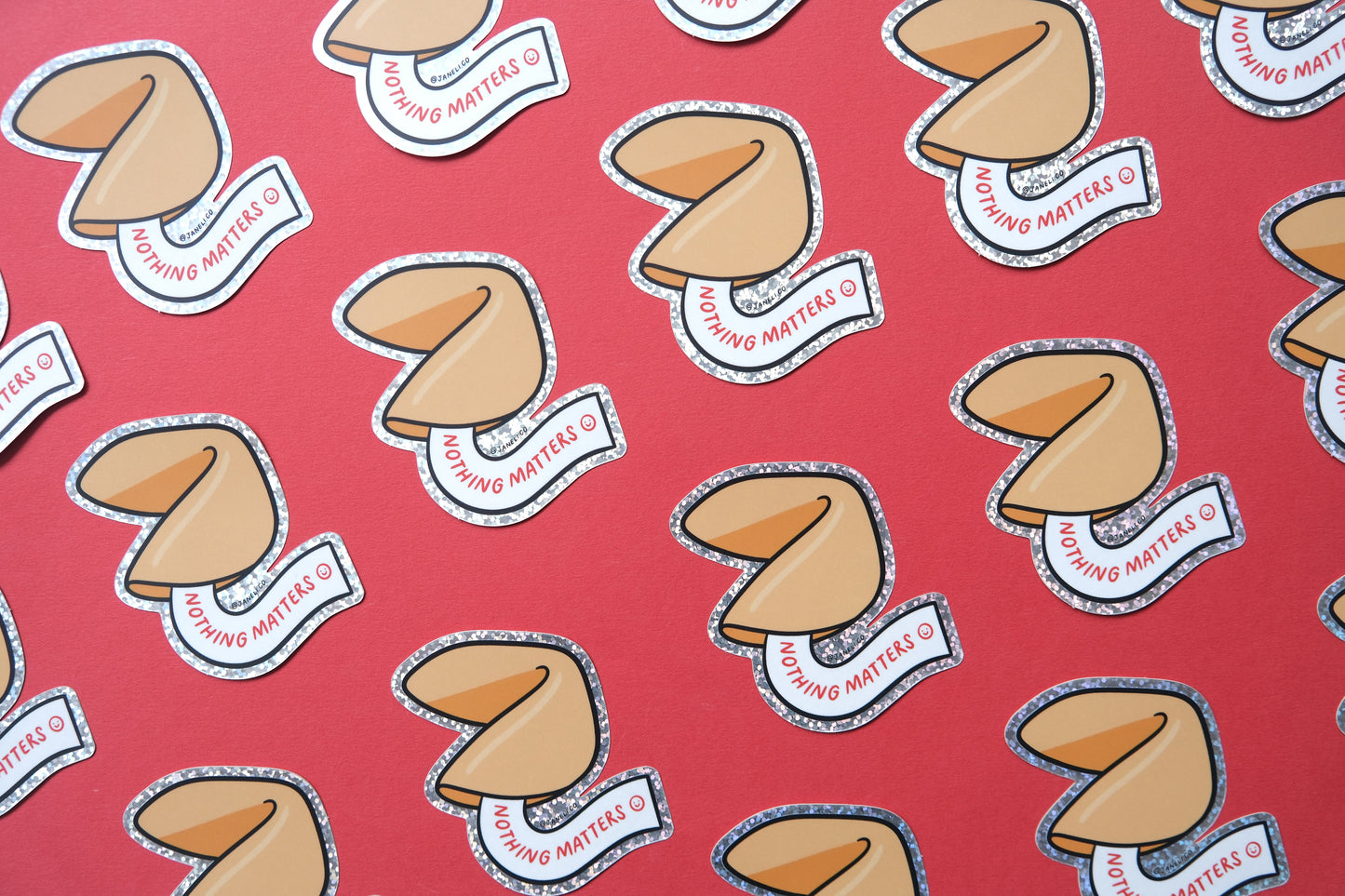 A grid of JaneLi.Co stickers of fortune cookies that say "Nothing Matters" over a red background.