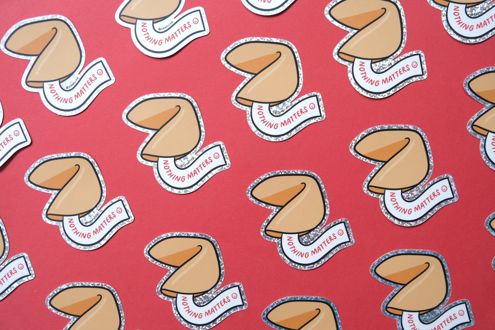 A grid of JaneLi.Co stickers of fortune cookies that say "Nothing Matters" over a red background.
