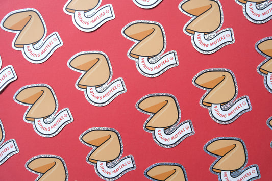 A grid of JaneLi.Co stickers of fortune cookies that say "Nothing Matters" over a red background.
