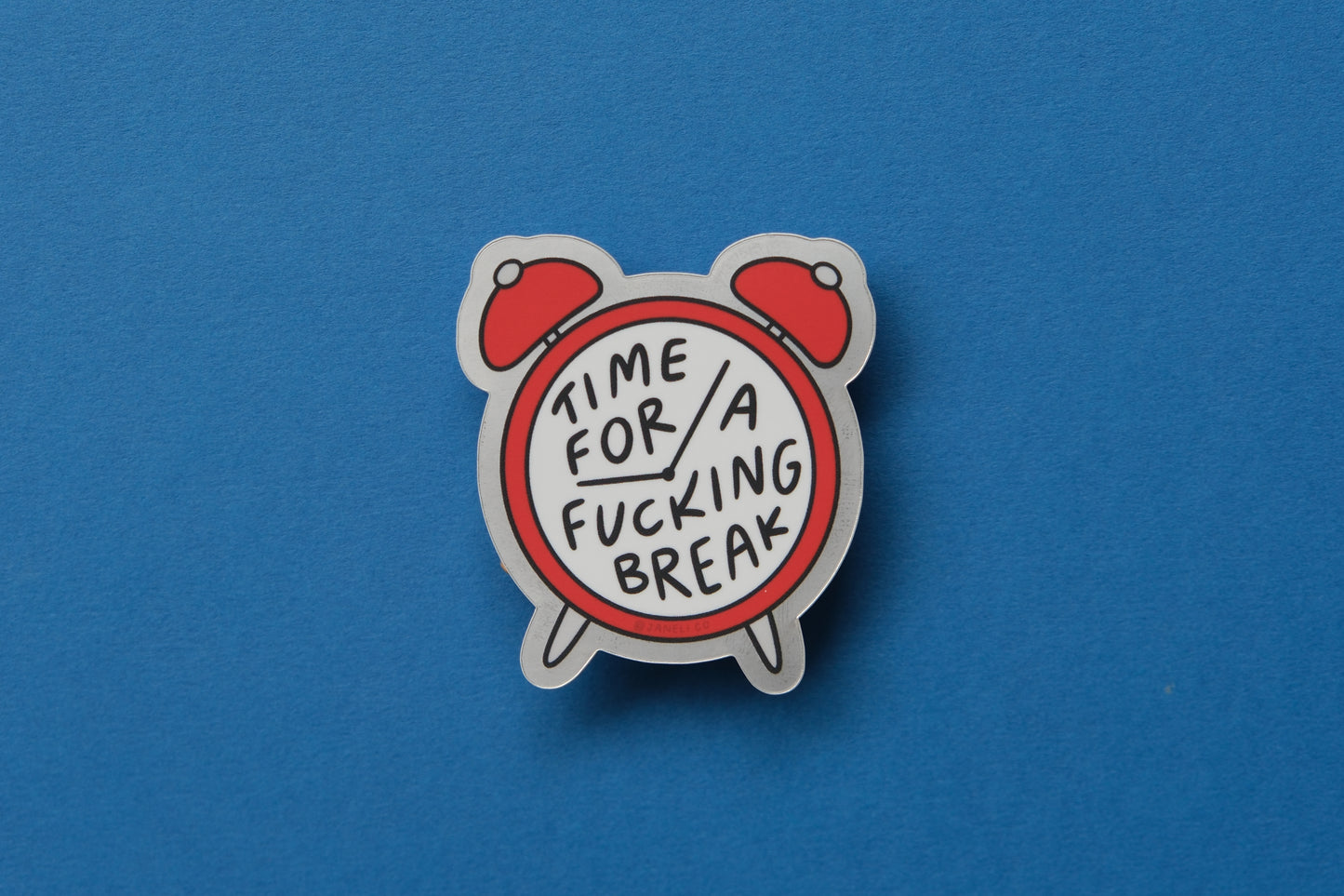 A JaneLi.Co sticker of an alarm clock that says "Time for a Fucking Break" on the face over a blue background.
