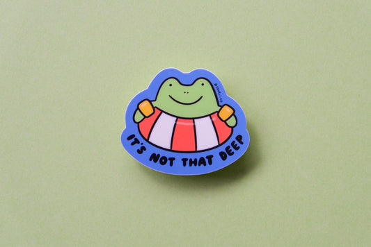 A JaneLi.Co sticker of a frog floating in a lifessaver tube that says "It's not that deep" over a green background.