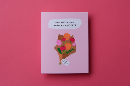 A photo of a greeting card a bouquet of flowers with a tag that says "Happy Galentine's Day" and "Who needs a man when you have me" on a pink background.