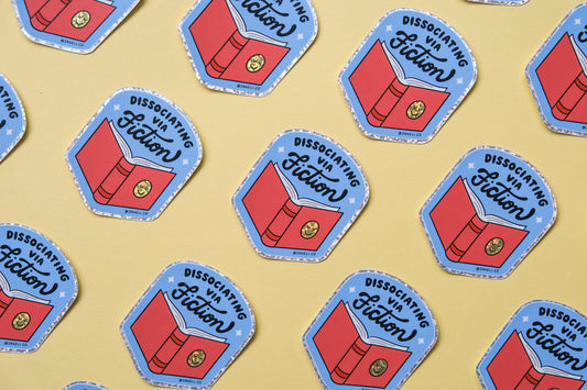 A grid of JaneLi.Co stickers of badges with books that say "Dissociating via Fiction" over a yellow background.