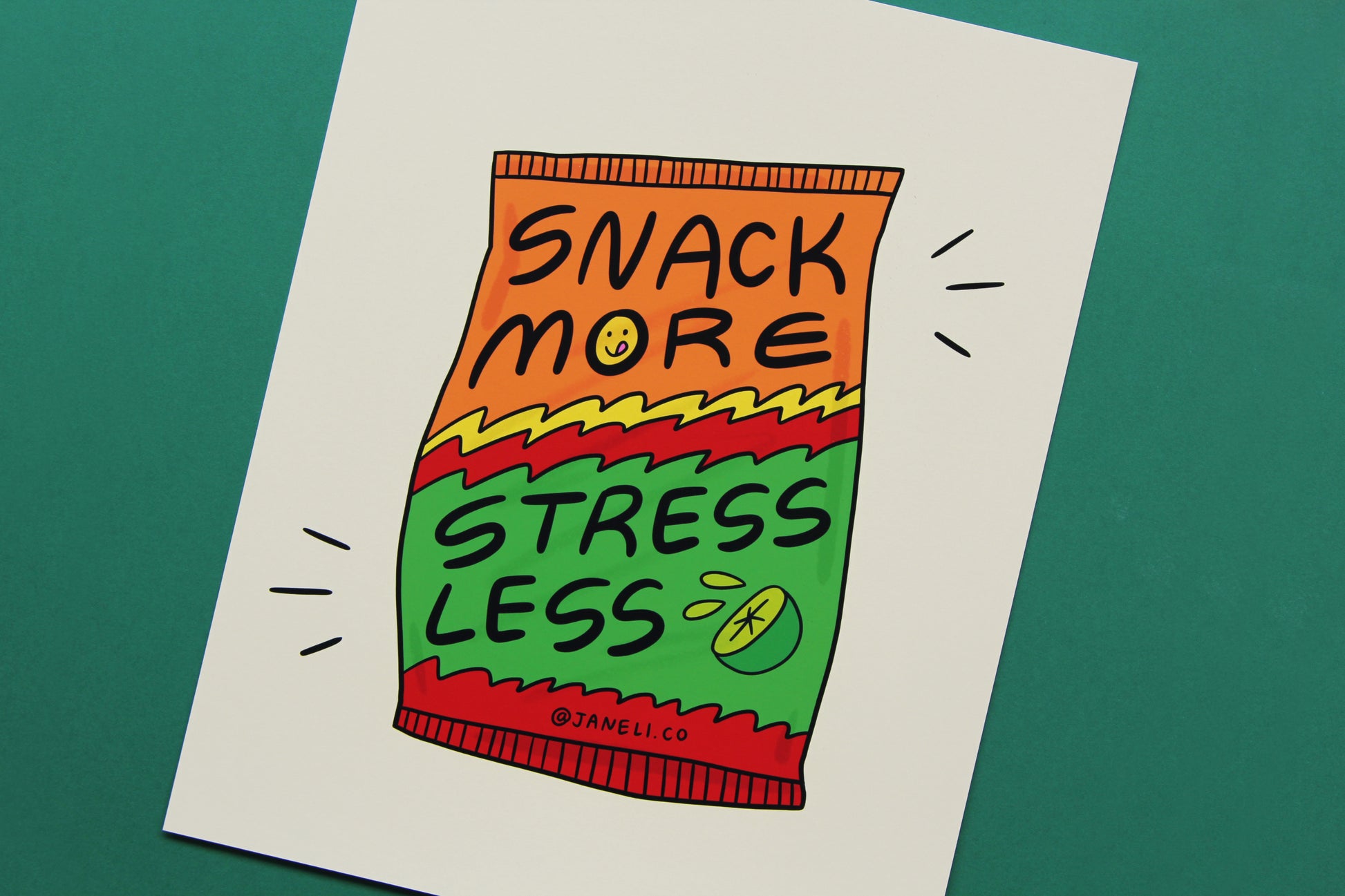 A JaneLi.Co print that says "Snack More Stress Less" on a spicy lime chip bag over a green background.