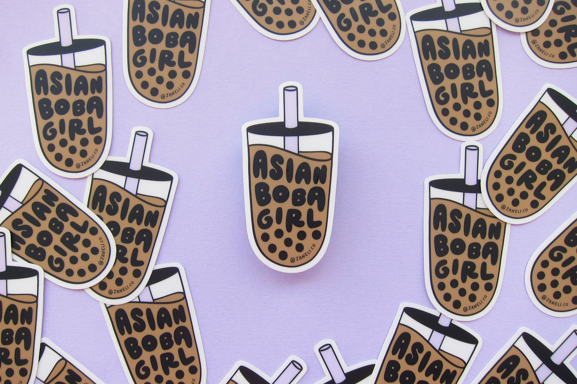 A grid of JaneLi.Co stickers that say "Asian Boba Girl" in the shape of cups of boba over a lavender background.
