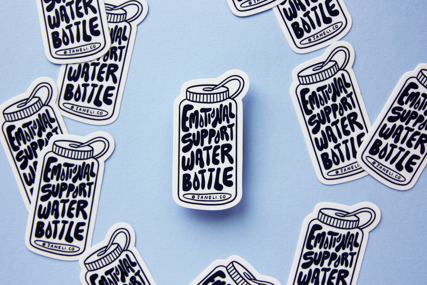 A grid of black and white JaneLi.Co stickers that say "Emotional Support Water Bottle" in the shape of a water bottle over a sky blue background.