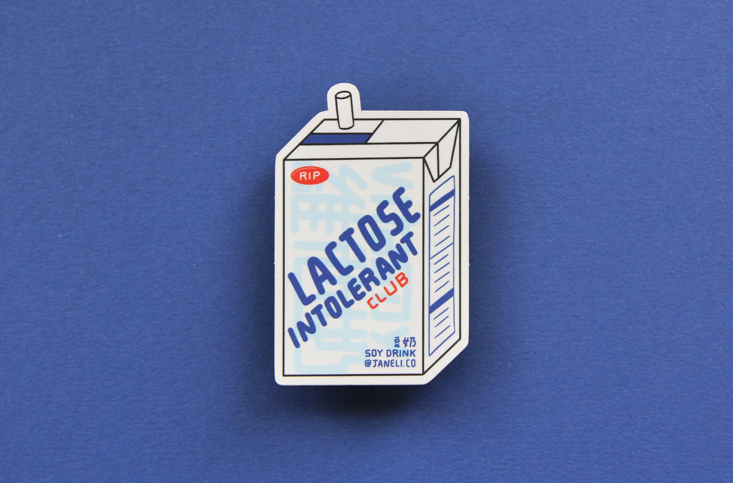 A JaneLi.Co sticker that says "Lactose Intolerant Club" in the shape of a soymilk carton with a straw over a navy blue background.