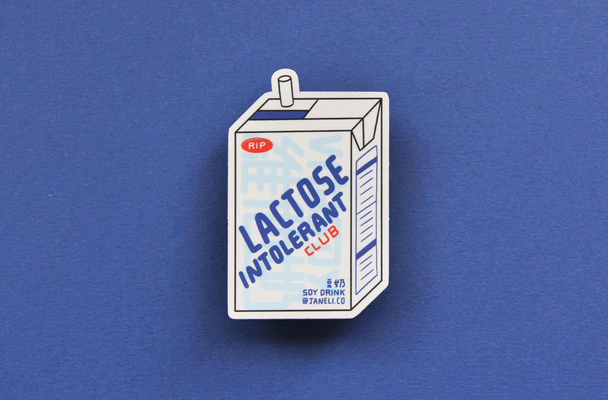 A JaneLi.Co sticker that says "Lactose Intolerant Club" in the shape of a soymilk carton with a straw over a navy blue background.