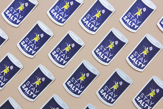 A grid of JaneLi.Co stickers that say "Stay Salty" in the shape of salt cans with angry salt girls holding umbrellas blow backwards from wind and rain over a navy blue background.