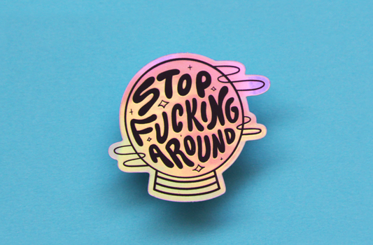 A holographic JaneLi.Co sticker that says "Stop Fucking Around" in a magic crystal ball over a blue background.