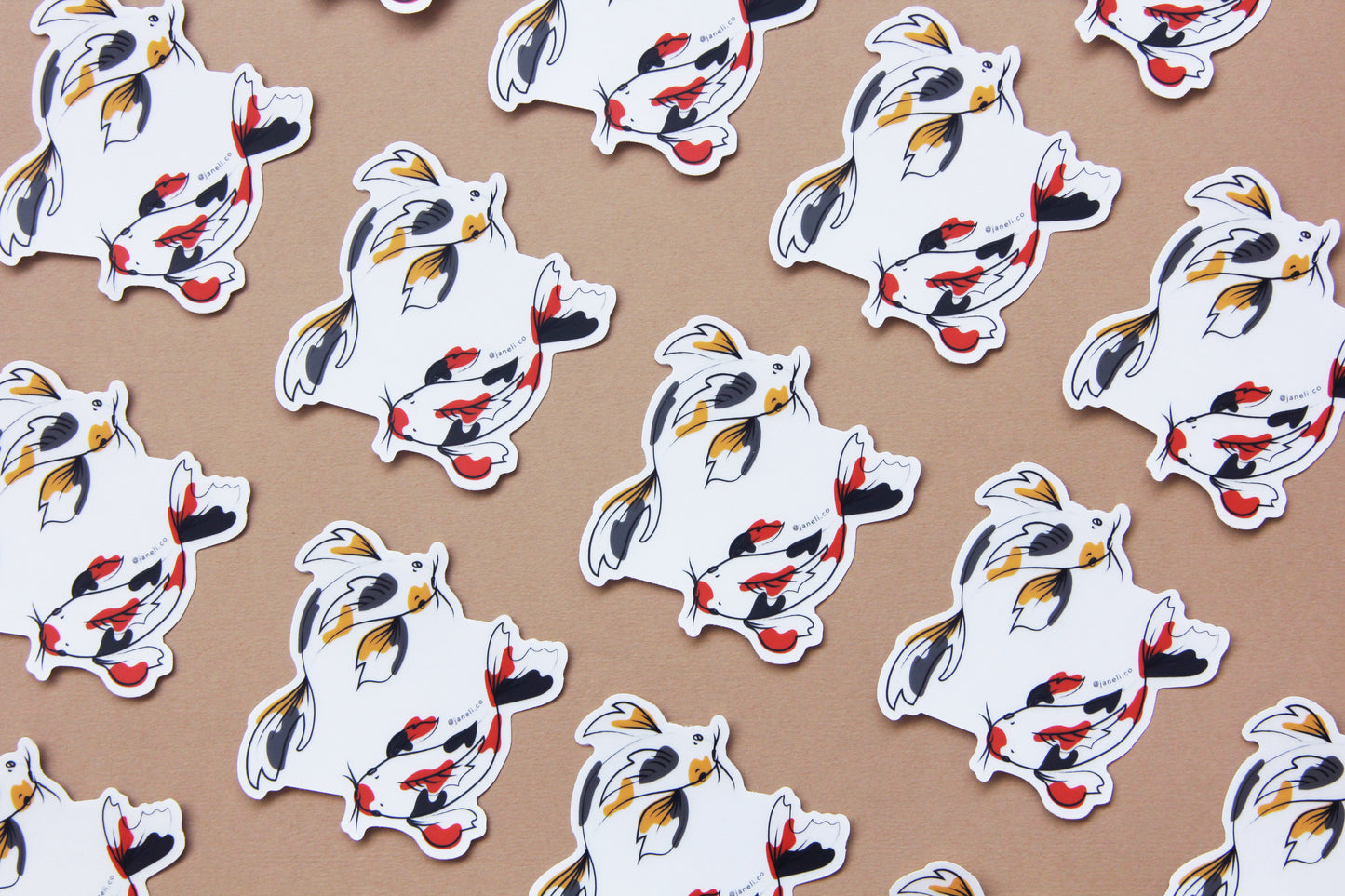 A grid of JaneLi.Co stickers of gold and grey koi fish and scarlet and black koi fish swimming in a circle over a tan background.