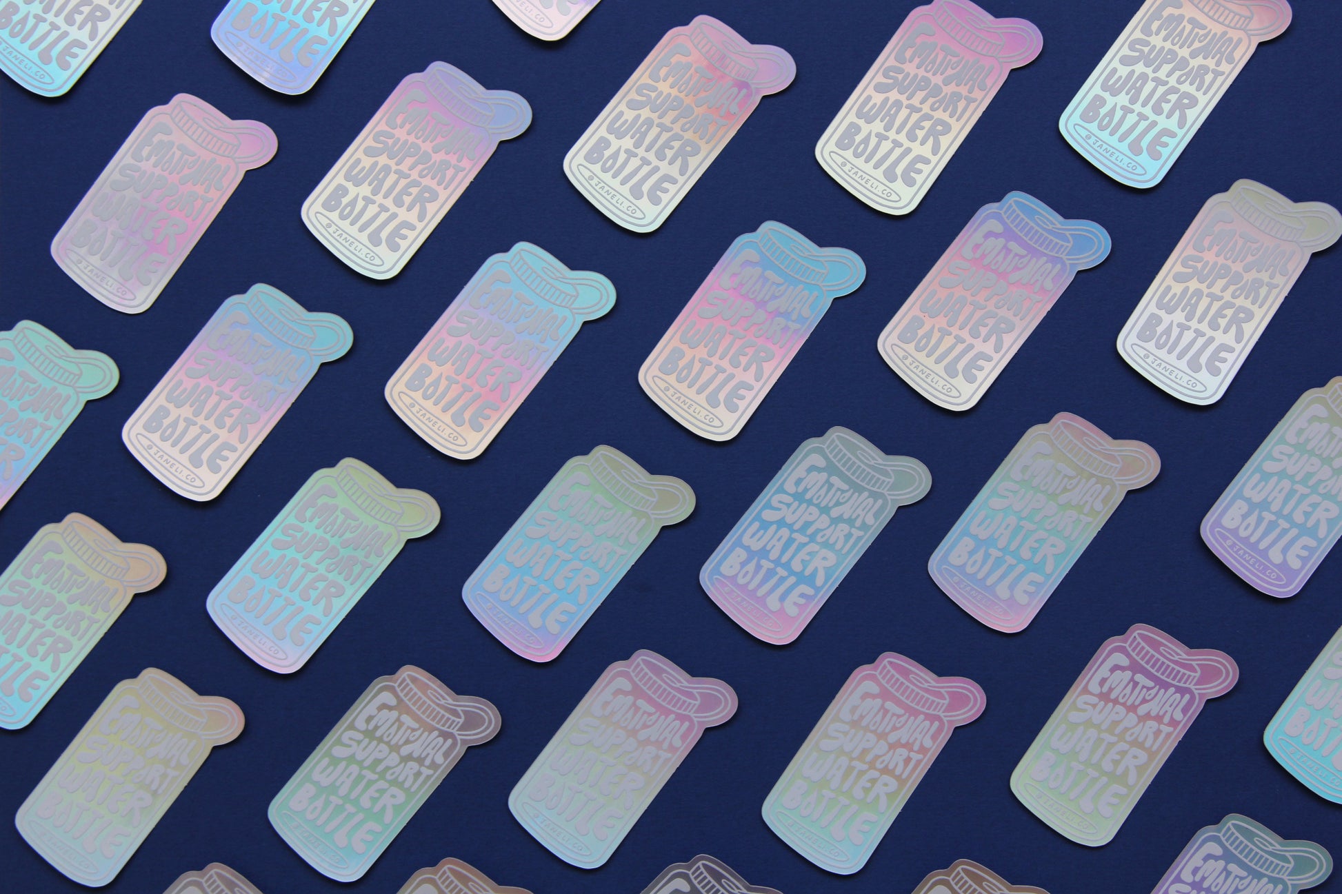 A grid of holographic JaneLi.Co stickers that say "Emotional Support Water Bottle" in the shape of a water bottle over a navy blue background.