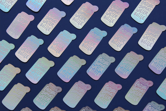 A grid of holographic JaneLi.Co stickers that say "Emotional Support Water Bottle" in the shape of a water bottle over a navy blue background.
