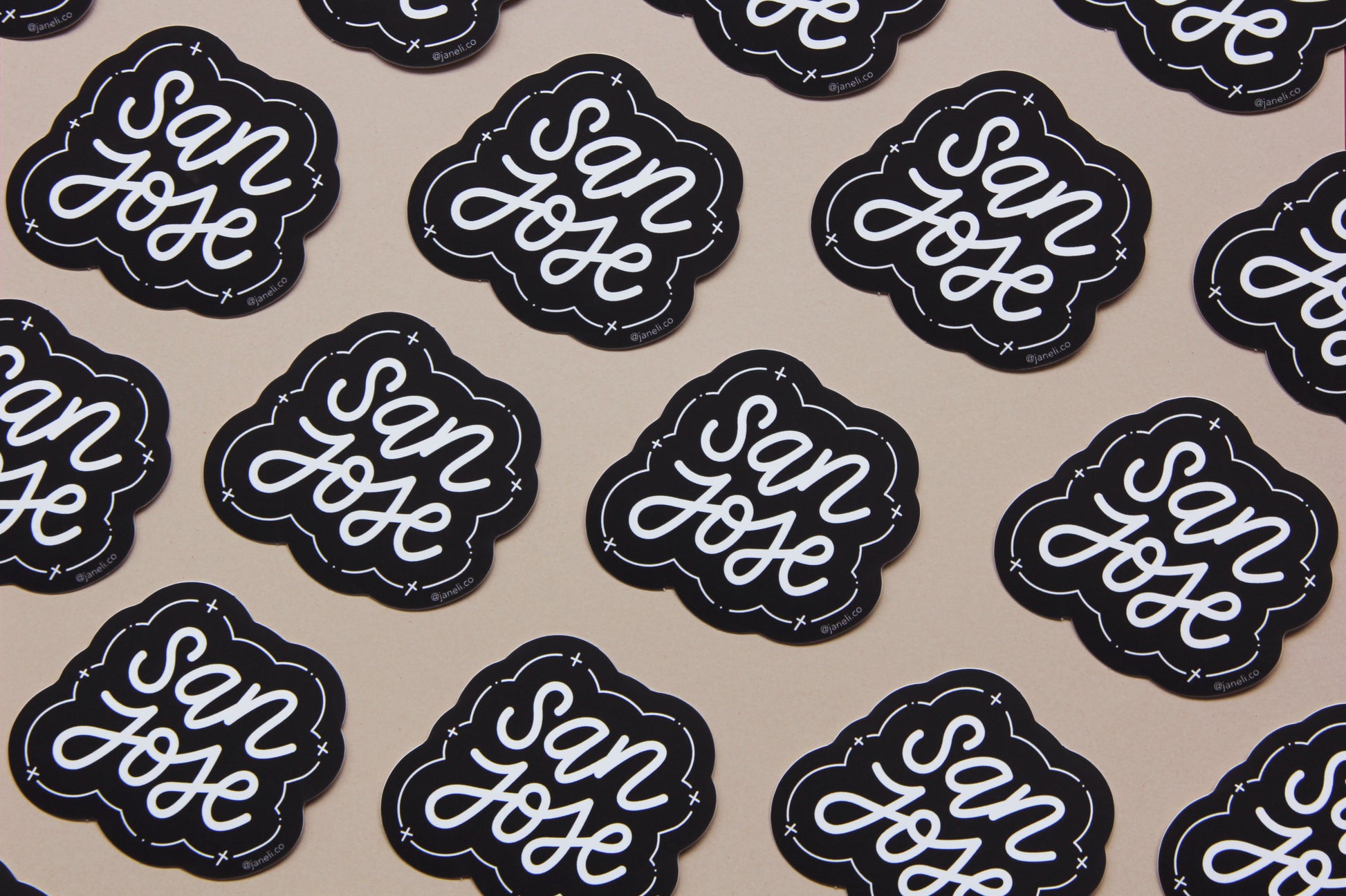 A grid of black and white JaneLi.Co stickers that say "San Jose" in cursive lettering over a tan background.