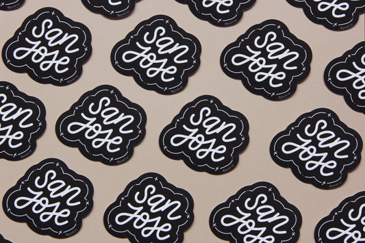 A grid of black and white JaneLi.Co stickers that say "San Jose" in cursive lettering over a tan background.