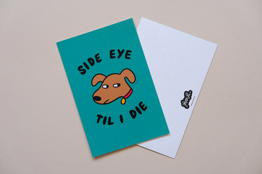 A JaneLi.Co mini print/postcard of a dog giving side eye that says "Side Eye" and a back postcard side of the same print over a cream background.