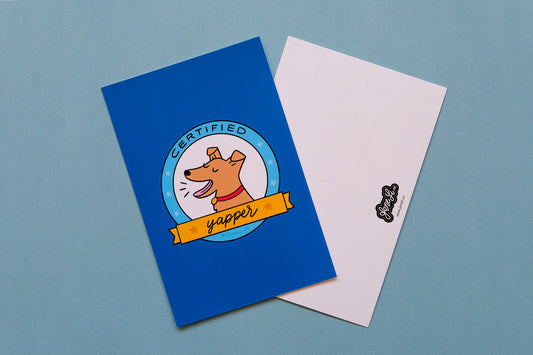 A JaneLi.Co mini print/postcard of a badge with a barking dog that says "Certified Yapper" and a back postcard side of the same print over a blue background.