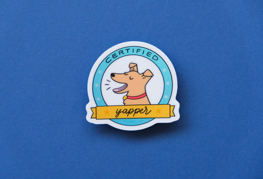 A JaneLi.Co sticker of a badge with a barking dog that says "Certified Yapper" over a blue background.