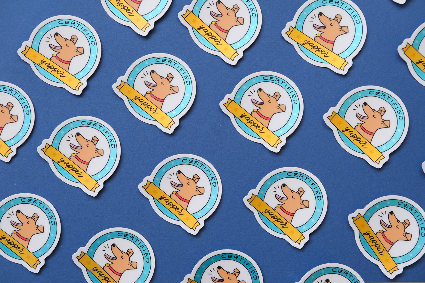 A grid of JaneLi.Co stickers of badges with barking dogs that say "Certified Yapper" over a blue background.