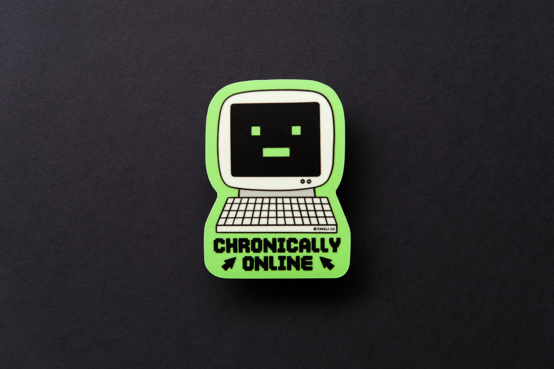 A JaneLi.Co sticker of a retro computer with a -_- face that says "Chronically Online" over a black background.