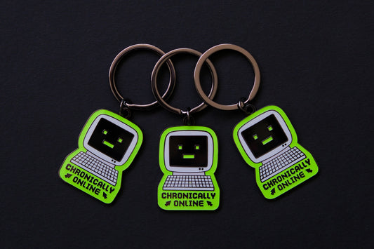 3 enamel keychains of retro computers that say "Chronically Online" over a black background.