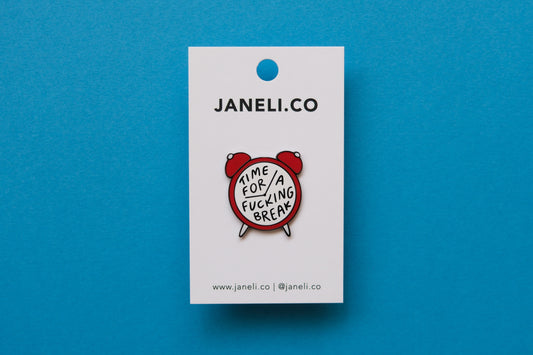 An enamel pin of an alarm clock that says "Time for a Fucking Break" on a white JaneLi.Co backing card over a blue background.