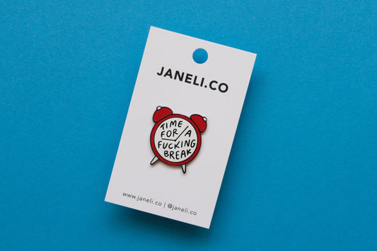 An enamel pin of an alarm clock that says "Time for a Fucking Break" on a white JaneLi.Co backing card over a blue background.