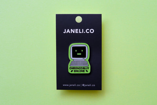 An enamel pin of a retro computer that says "Chronically Online" on a black JaneLi.Co backing card over a green background.