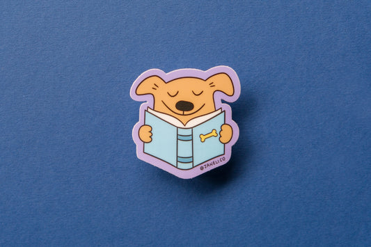 A JaneLi.Co sticker of a dog reading a book over a dark blue background.