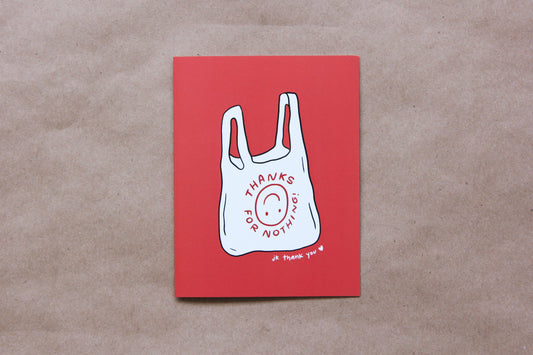 A photo of a red greeting card with a takeout bag that says "Thanks For Nothing jk thank you <3" on a tan background.