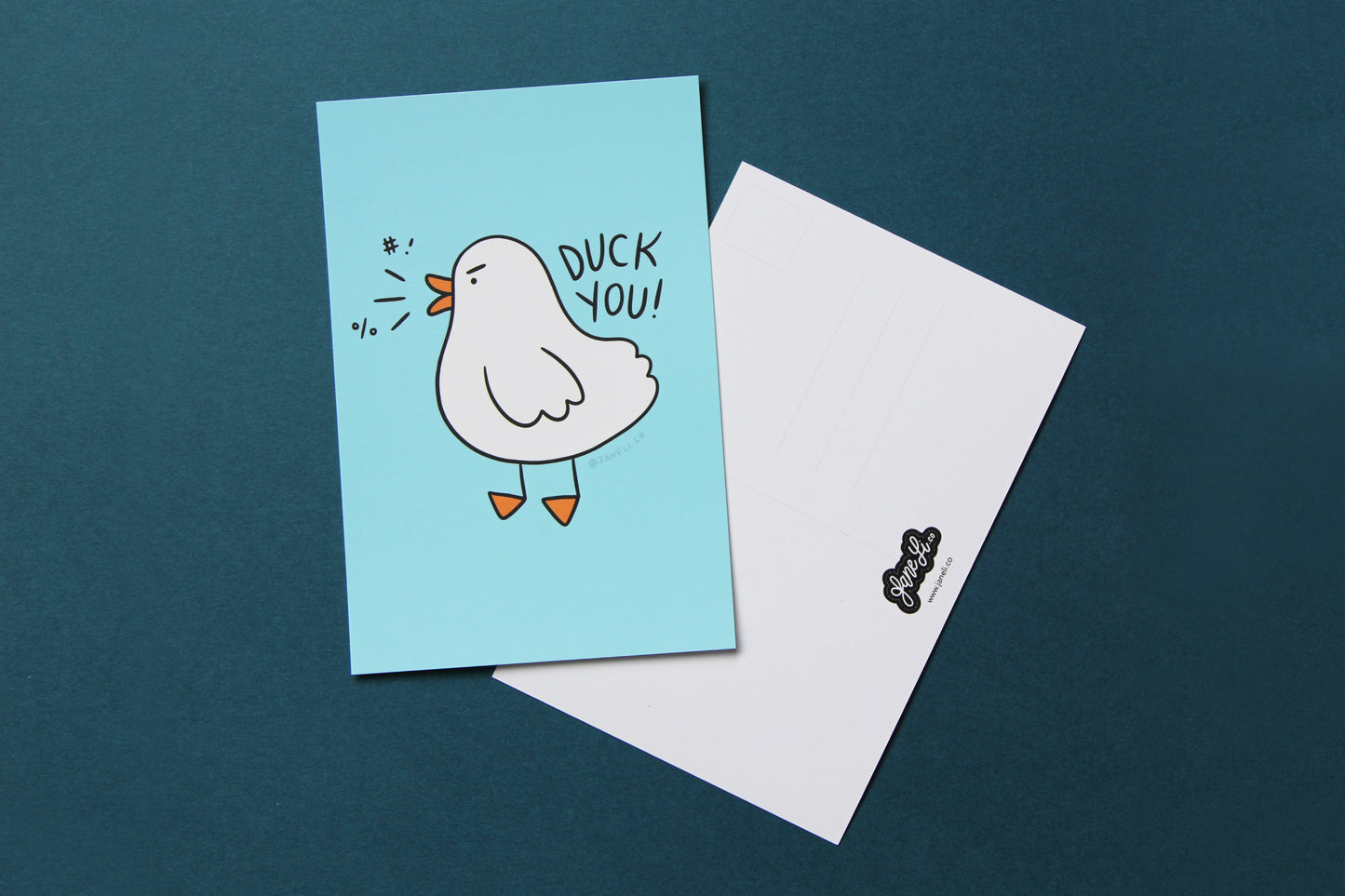 A JaneLi.Co mini print/postcard of an angry duck that says "Duck You!" and a back postcard side of the same print over a blue background.