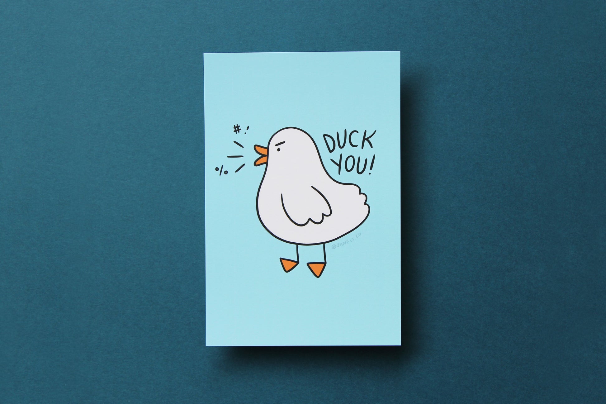 A JaneLi.Co mini print/postcard of an angry duck that says "Duck You!" over a blue background.
