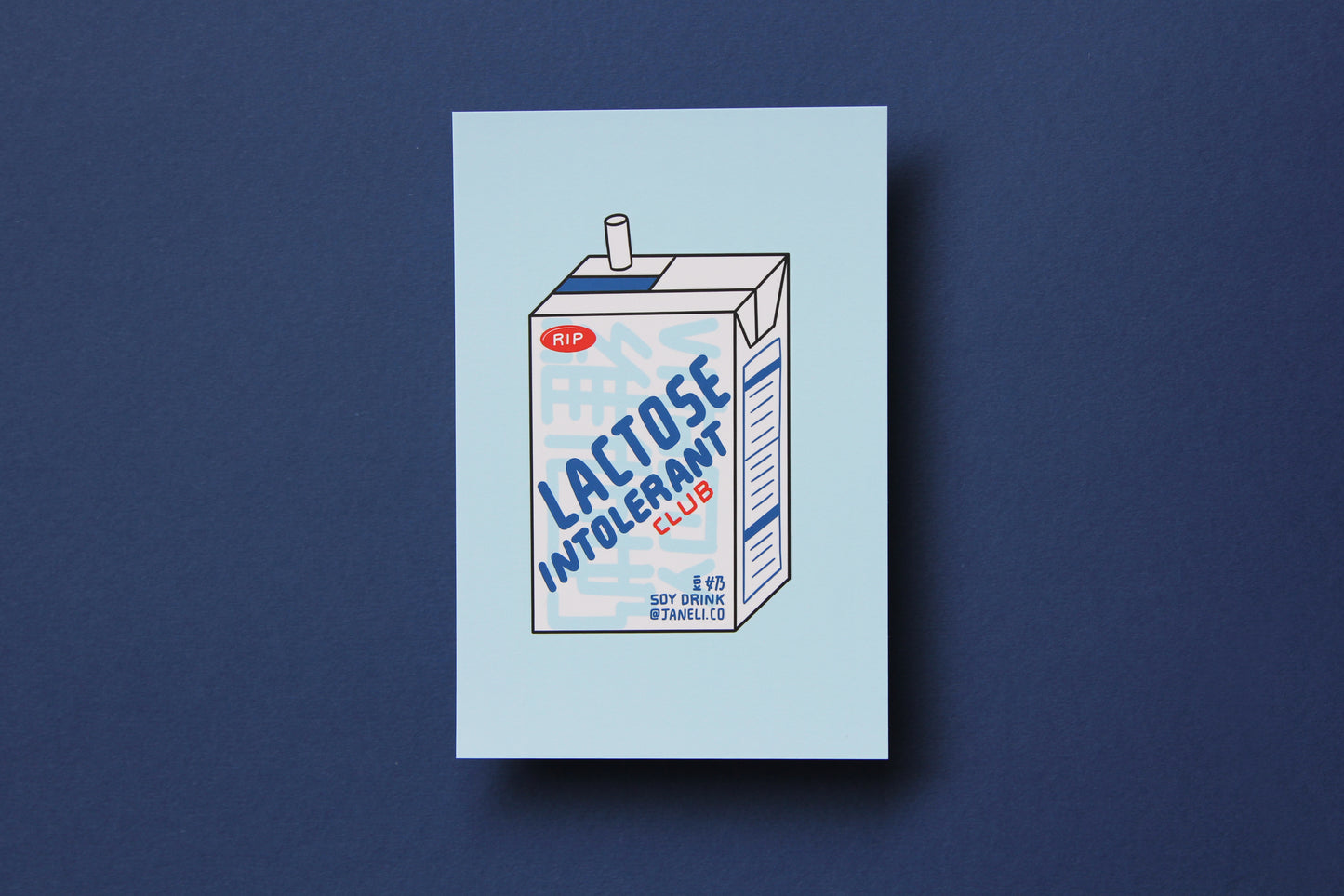 A JaneLi.Co mini print/postcard of a soymilk carton that says "Lactose Intolerant Club" over a navy blue background. 
