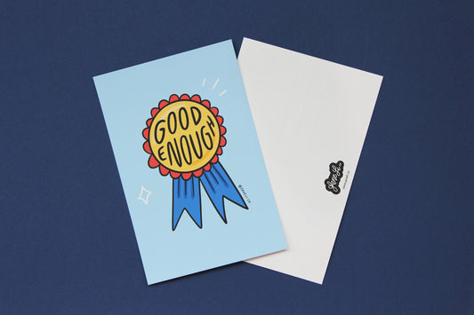 A JaneLi.Co mini print/postcard of an award ribbon that says "Good Enough" and a back postcard side of the same print over a blue background.