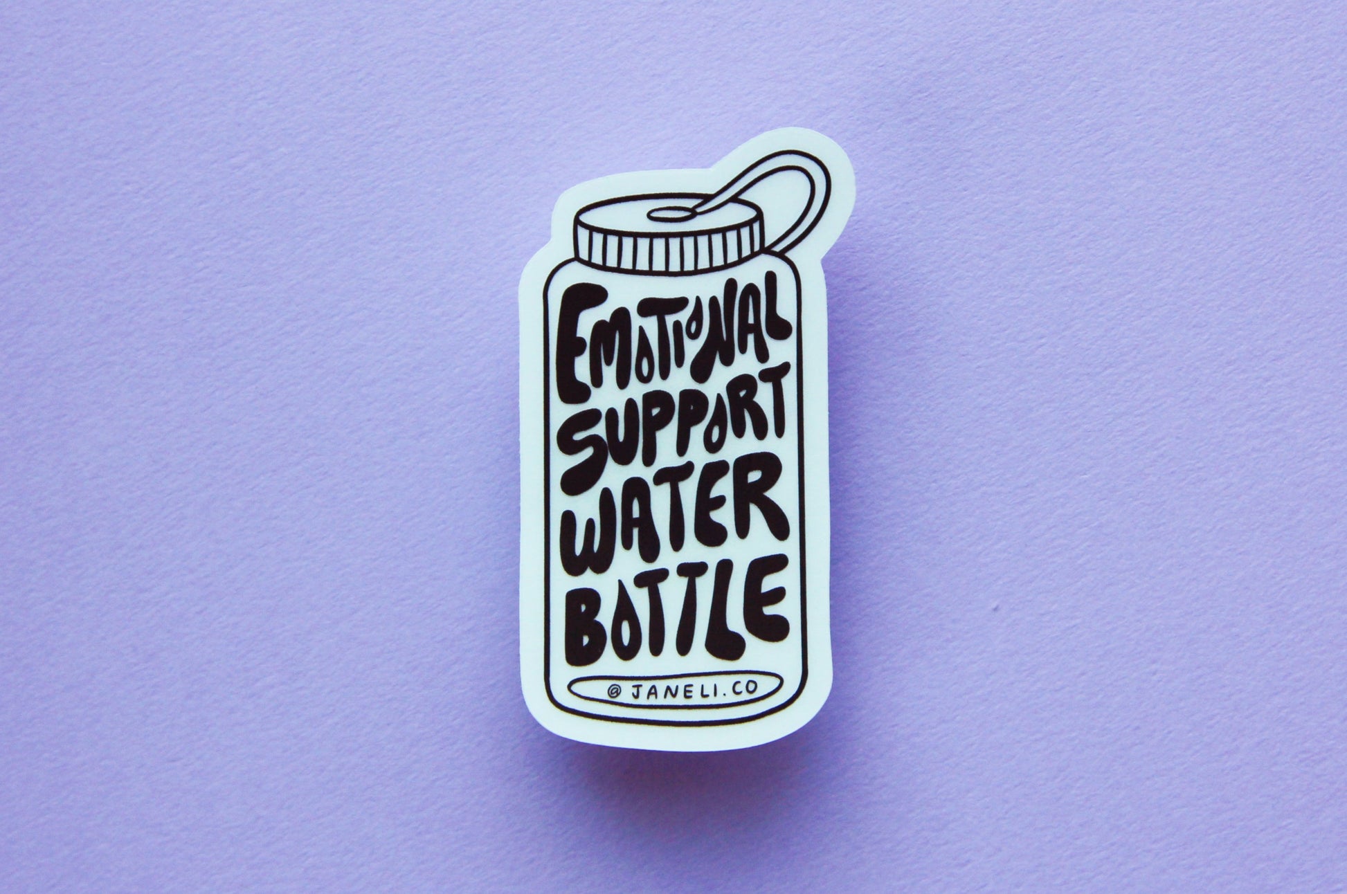 A JaneLi.Co sticker that says "Emotional Support Water Bottle" in the shape of a water bottle over a lavender background.