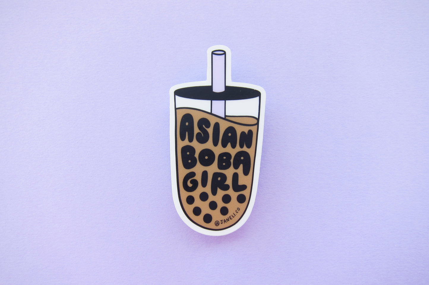 A JaneLi.Co sticker that says "Asian Boba Girl" in the shape of a cup of boba over a lavender background. 