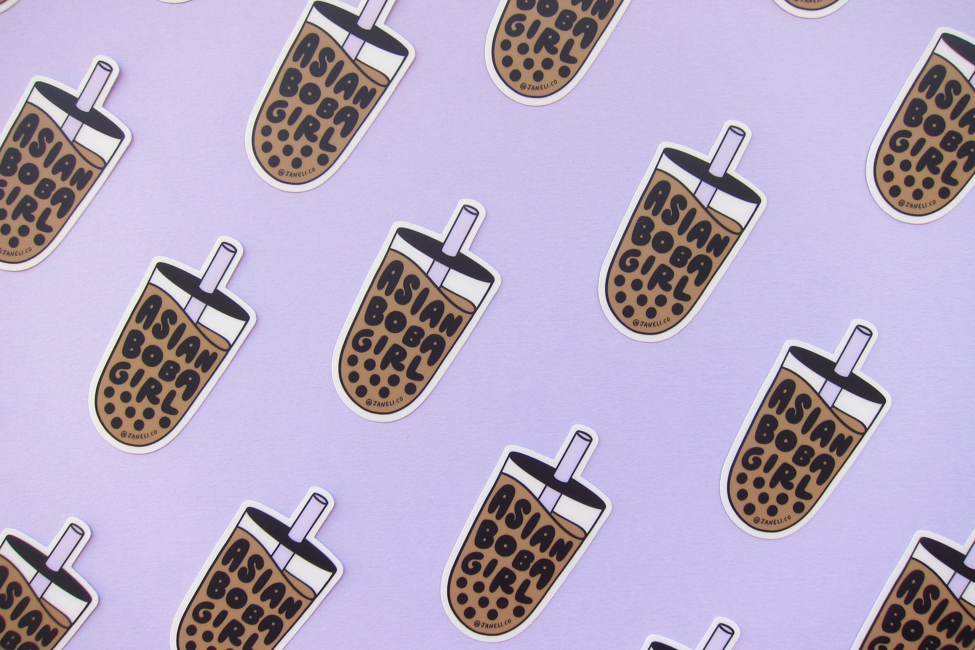 A grid of JaneLi.Co stickers that say "Asian Boba Girl" in the shape of cups of boba over a lavender background. 