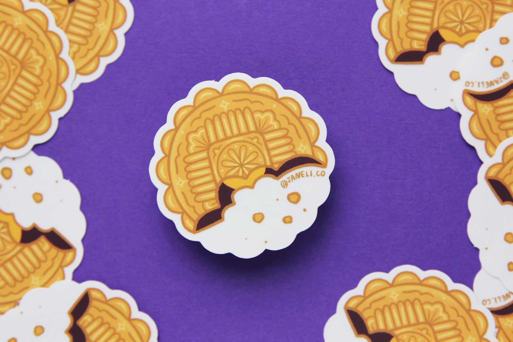 A grid of JaneLi.Co mooncake stickers over a purple background. 