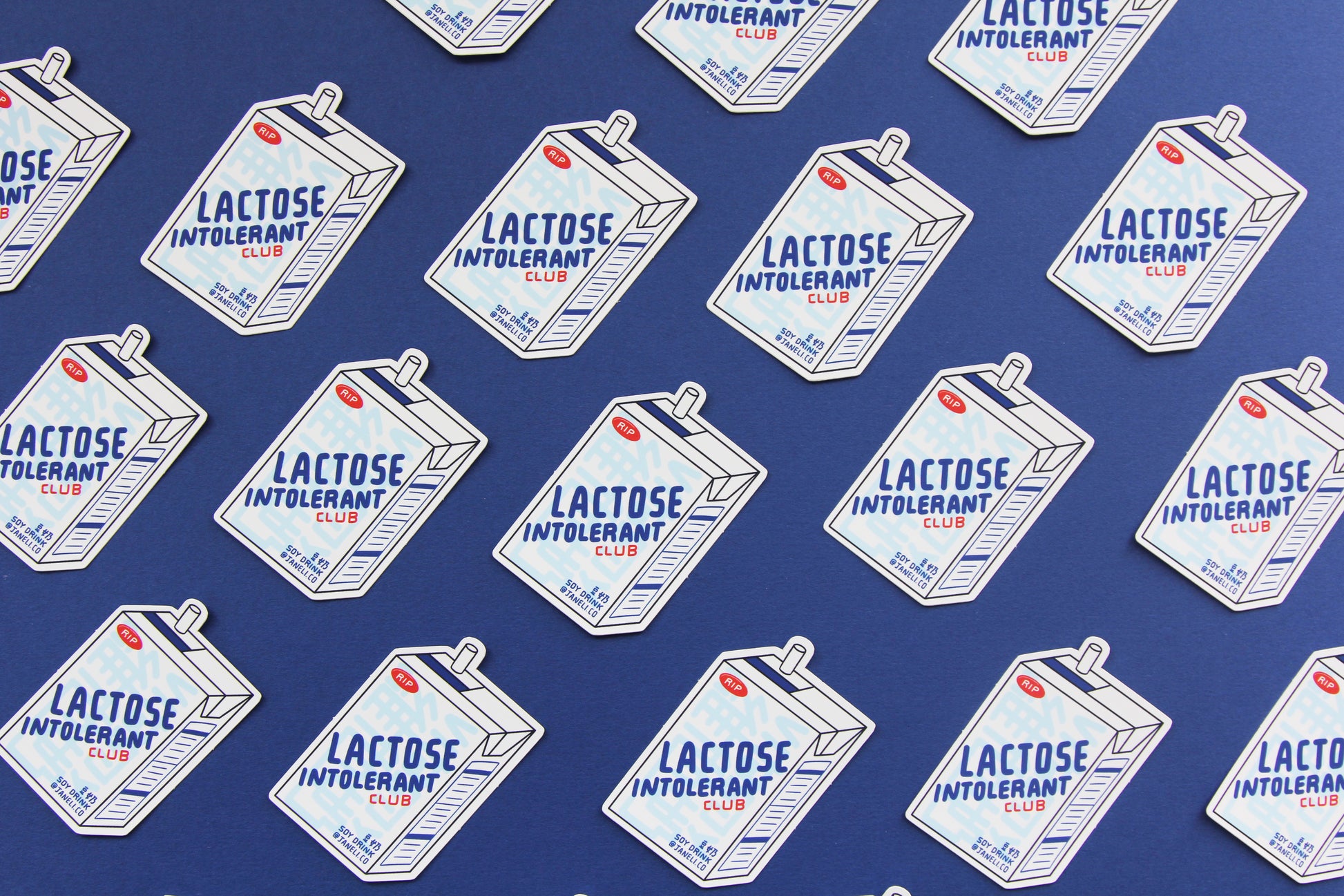 A grid of JaneLi.Co stickers that say "Lactose Intolerant Club" in the shape of soymilk cartons with straws over a navy blue background. 