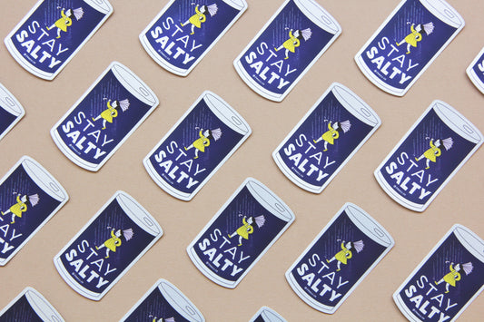 A grid of JaneLi.Co stickers that say "Stay Salty" in the shape of salt cans with angry salt girls holding umbrellas blow backwards from wind and rain over a navy blue background. 