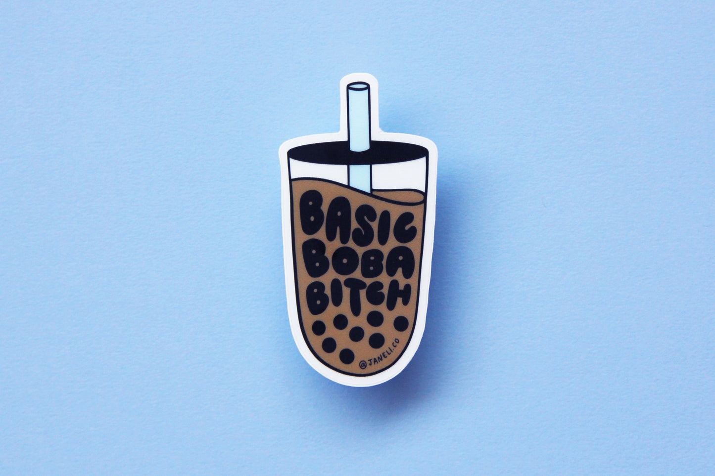 A JaneLi.Co sticker that says "Basic Boba Bitch" in the shape of a cup of boba over a sky blue background. 