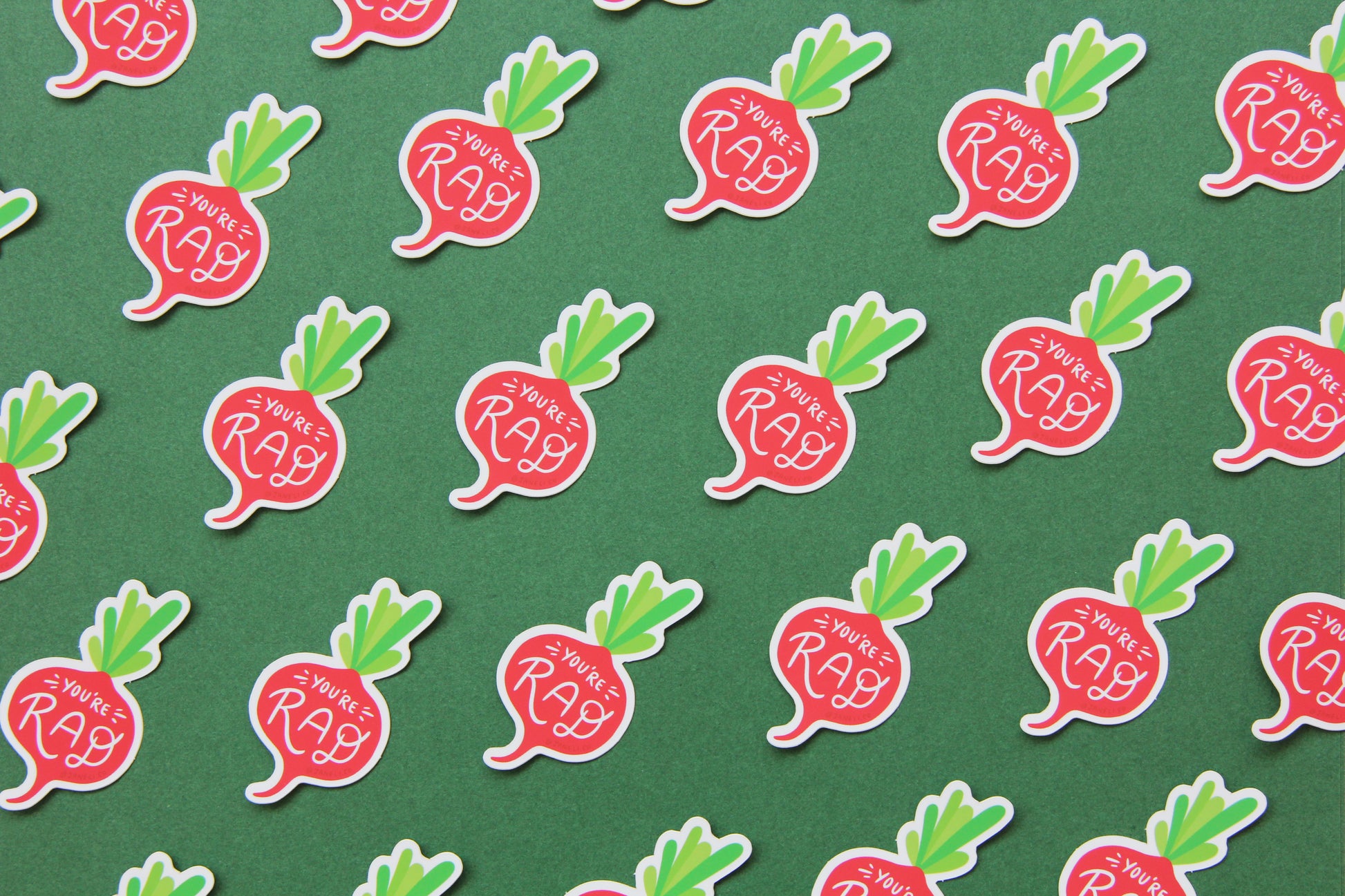 A grid of cute JaneLi.Co stickers that say "You're Rad" in the shape of small radished over a green background. 