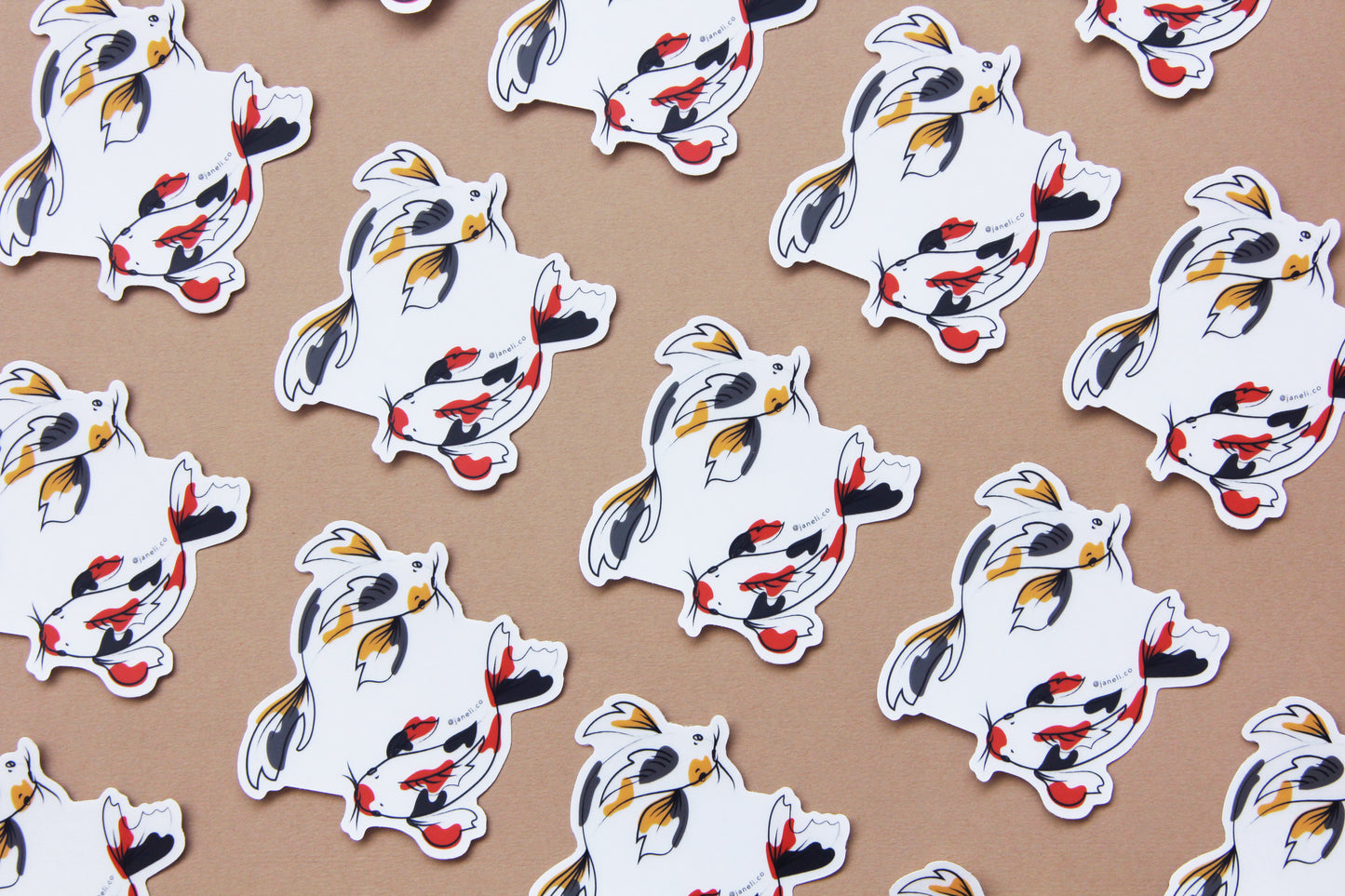 A grid of JaneLi.Co stickers of gold and grey koi fish and scarlet and black koi fish swimming in a circle over a tan background. 