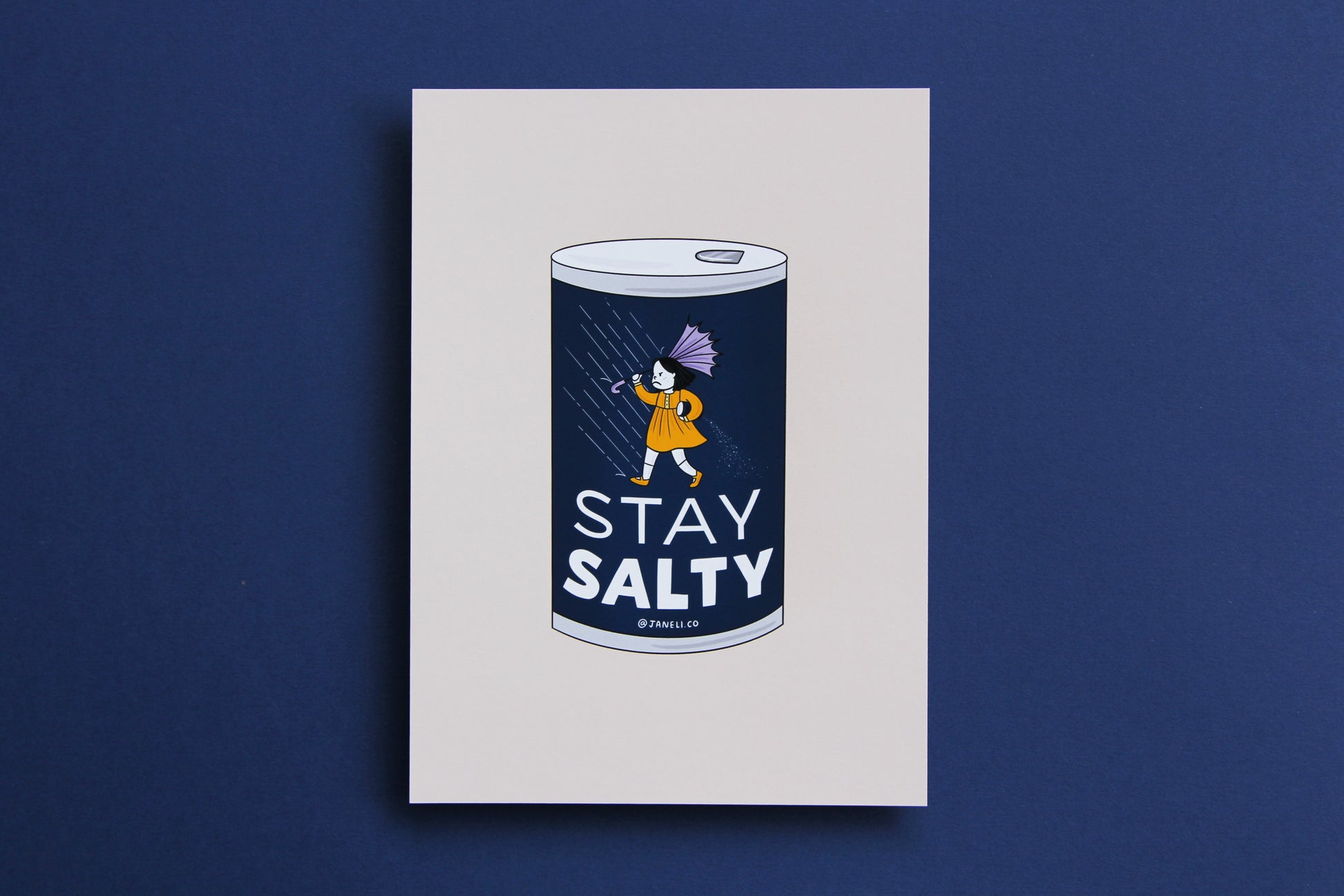 A JaneLi.Co print that shows a grumpy salt girl spilling a can of salt in the rain over a navy background.