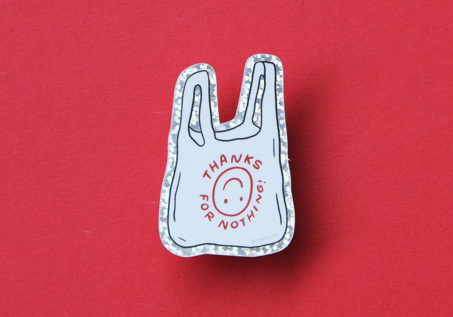 A JaneLi.Co sticker that says "Thanks For Nothing" in the shape of a plastic takeout bag over a red background.