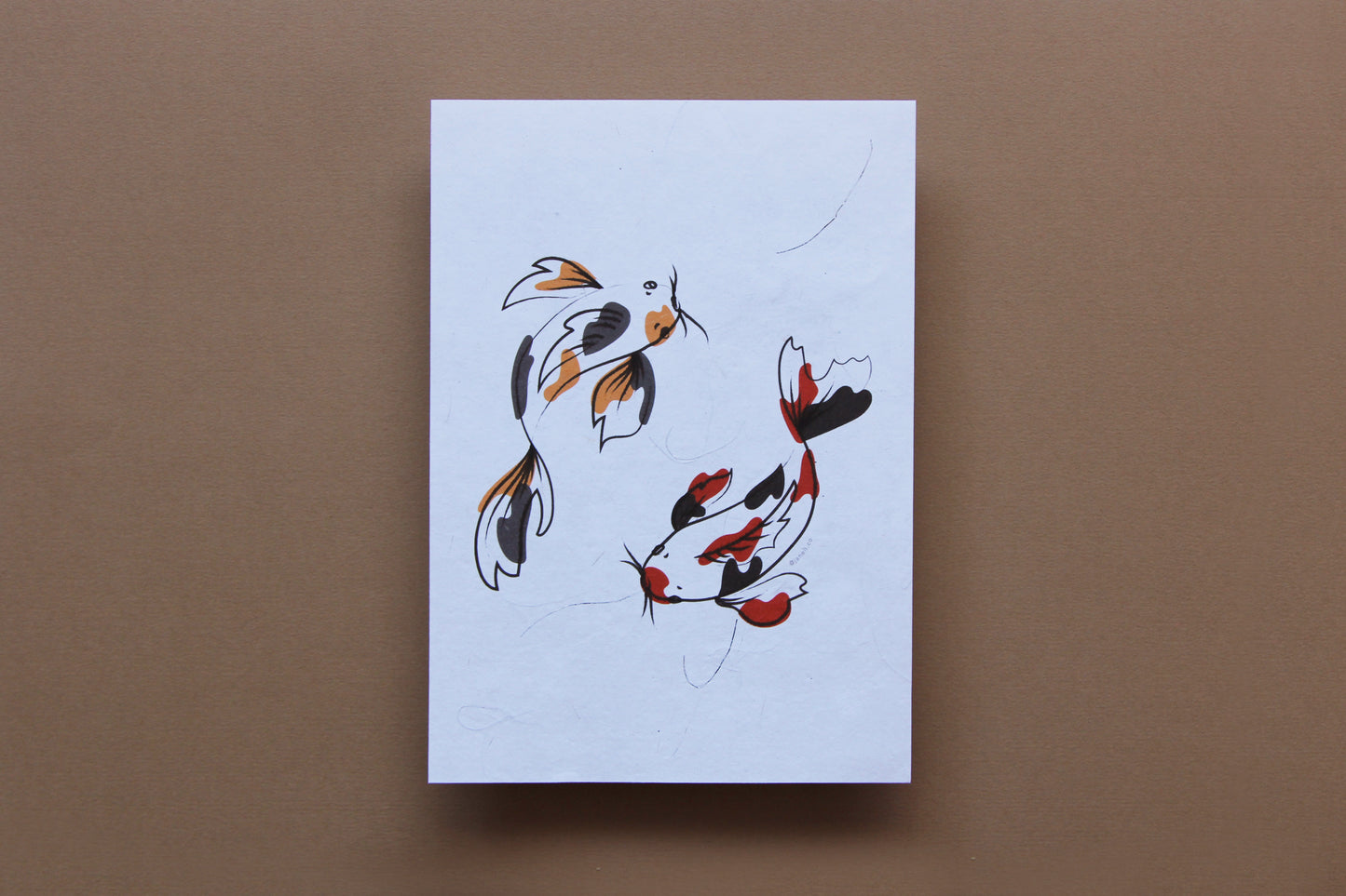 A JaneLi.Co print of 2 circling koi over a tan background.