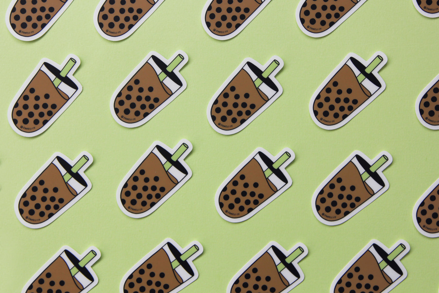 A grid of cute JaneLi.Co stickers showing a cup of a boba with a green straw over a green background.