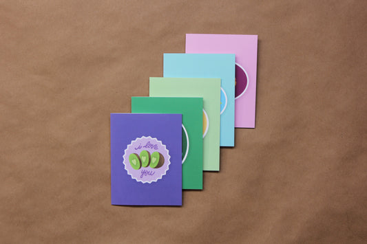 A photo of a stack of 5 Cut Fruit Love Language greeting cards.